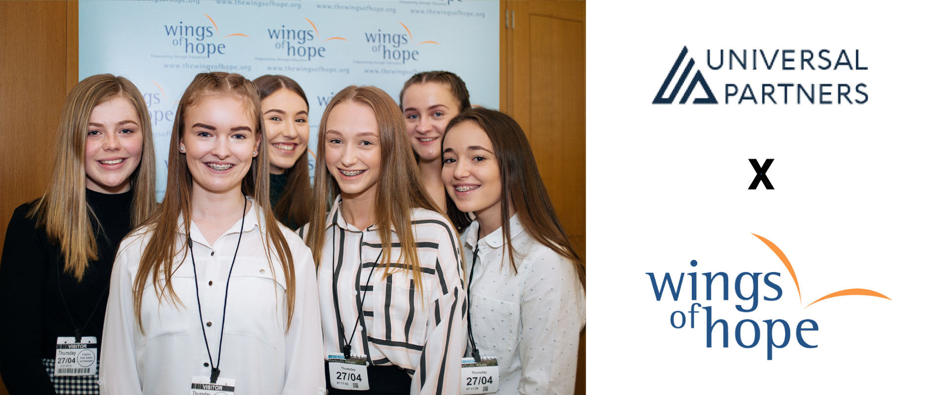 Wings of Hope students alongside the Universal Partners and Wings of Hope logos